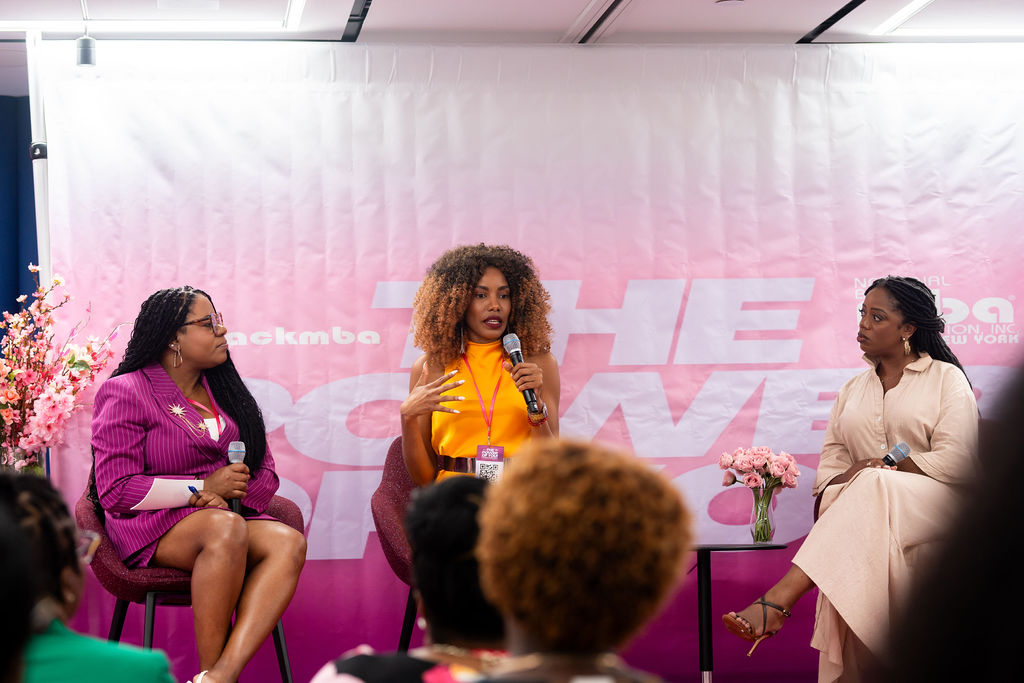 Shaw Bernard speaking with a microphone during a panel at the NY Black MBA Power of You event